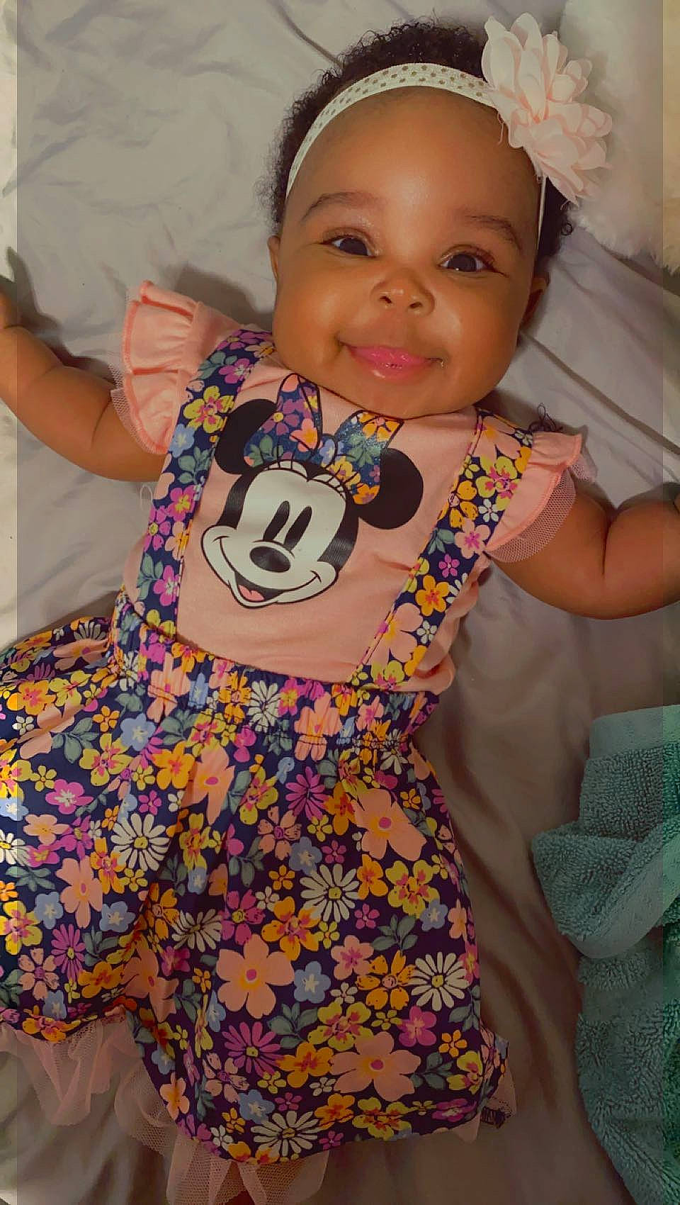 Amaria is registered to the contest to win money with this photo: arm, baby, baby_toddler_clothing, cheek, eye, face, facial_expression, finger, hairstyle, happy, head, joy, neck, pattern, person, pink, shoulder, sleeve, smile, t_shirt