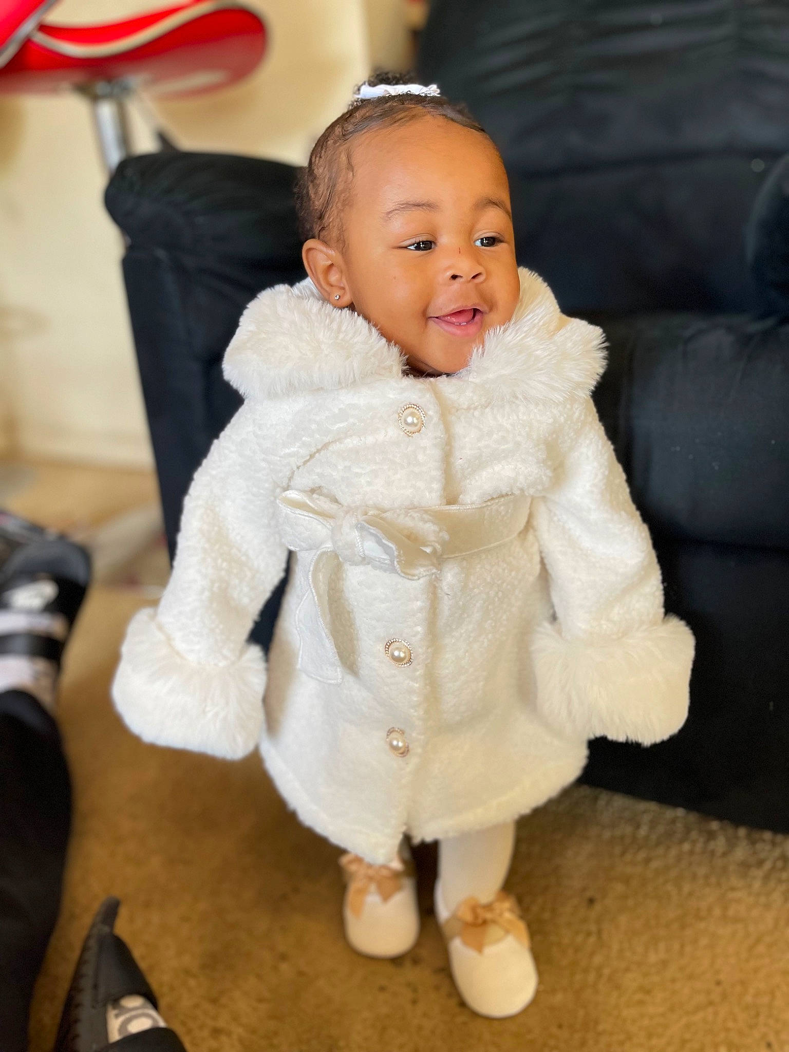Serenity is registered to the contest to win money with this photo: baby, baby_toddler_clothing, cheek, comfort, event, fashion_accessory, fashion_design, flooring, formal_wear, fun, fur, fur_clothing, happy, leg, person, sitting, skin, sleeve, smile, toddler
