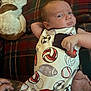 Sawyer joined the competition — help win amazing prizes! baby, infant, dog, couch, plaid, onesie, sports, football, volleyball, baseball, hand, tattoo, pet, relaxing, indoor, face, person, furniture, animal, resting