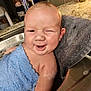 Sawyer is registered to the contest to win money with this photo: baby, bath, blue_towel, sink, smile, winking, water, bubbles, kitchen, towel, skin, infant, cute, child, wet, happy, resting, indoors, person, head