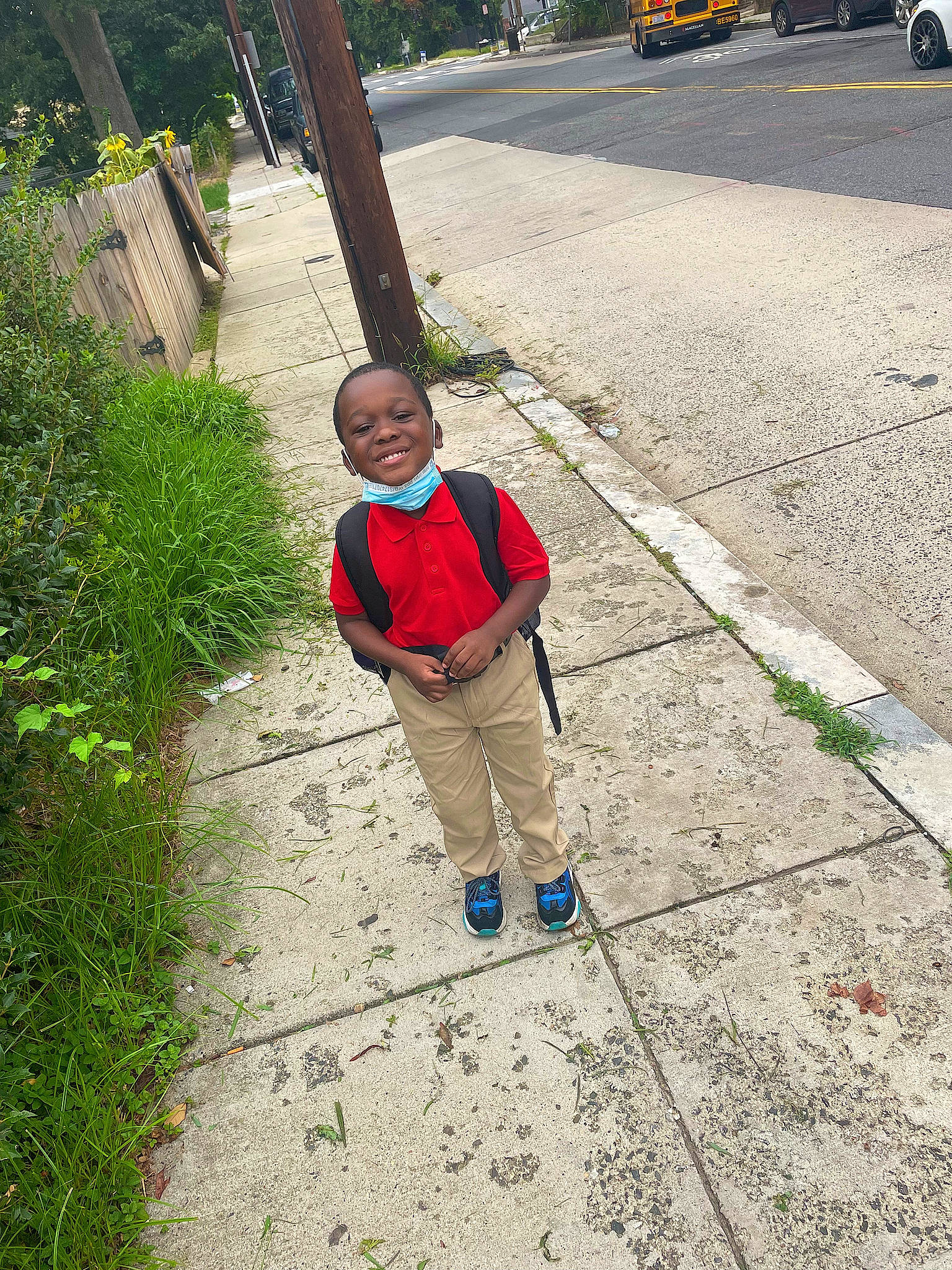Malachi is registered to the contest to win money with this photo: asphalt, car, child, flooring, grass, joy, leisure, pedestrian, person, plant, recreation, road, road_surface, sidewalk, smile, soil, street, tire, toddler, tree