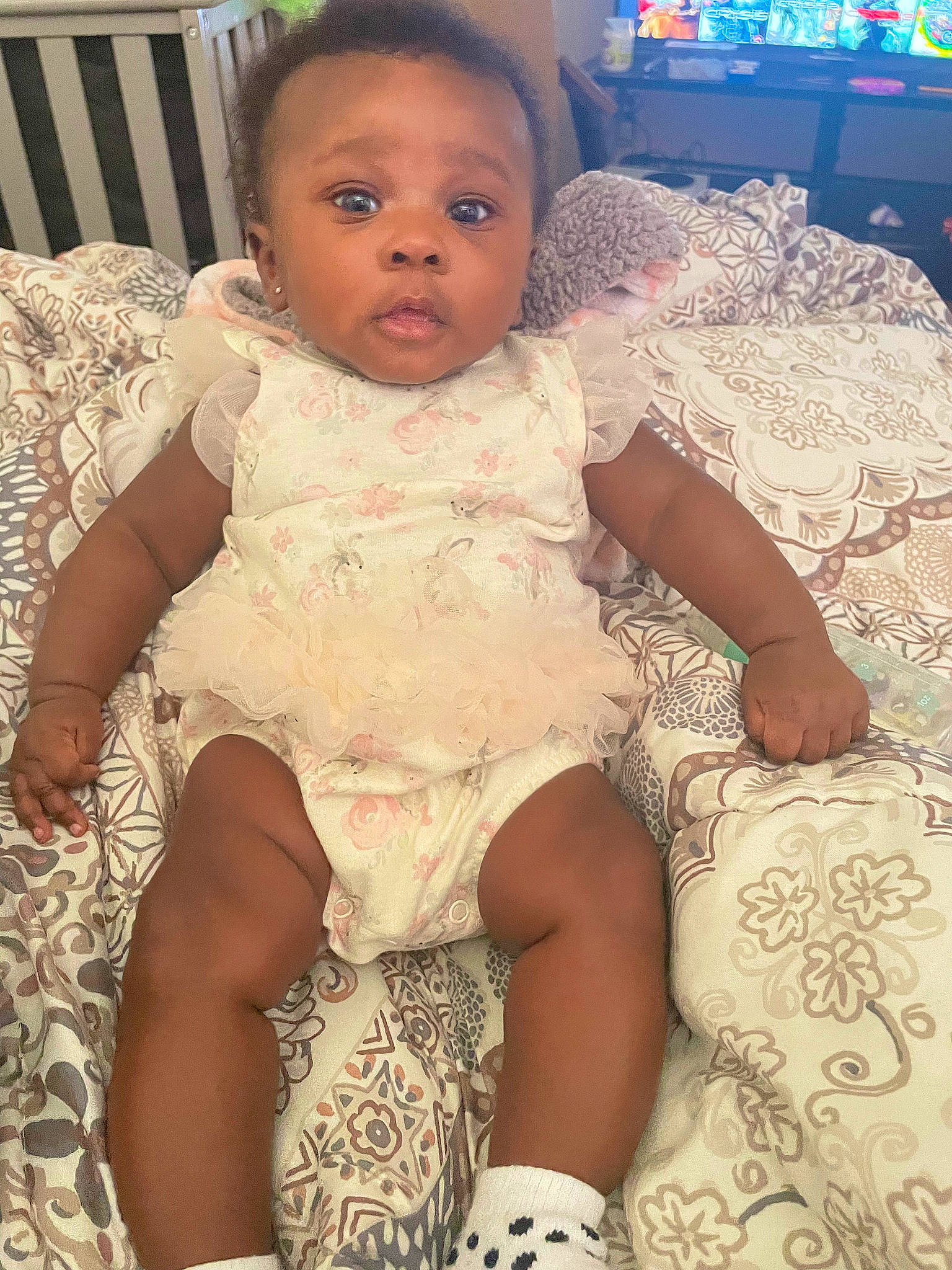 Meilani is registered to the contest to win money with this photo: baby_toddler_clothing, chair, cheek, chest, dress, eye, finger, hair, hand, happy, head, human_body, iris, mouth, neck, person, pink, skin, textile, thigh