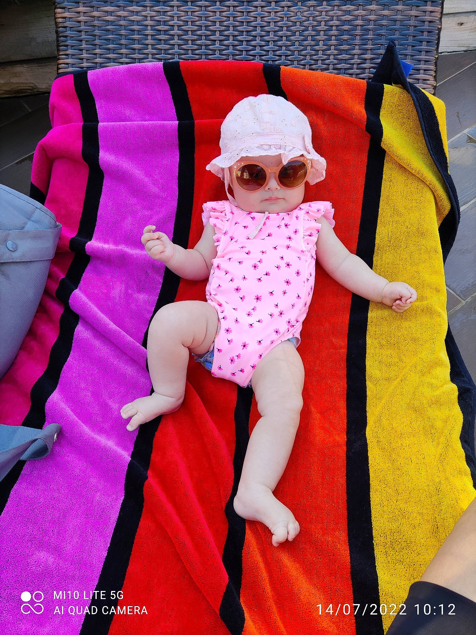Sylia participe au concours pour gagner de l'argent avec cette photo : arm, baby, baby_toddler_clothing, cap, comfort, doll, dress, glasses, goggles, hat, head, headwear, human_body, lap, magenta, person, pink, sleeve, sunglasses, textile