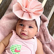Cataleya joined the competition — help win amazing prizes! baby, infant, pink, headband, bow, blanket, clothing, face, portrait, cute, soft, texture, wood, tank_top, logo, lying_down, child, skin, expression, adorable