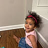 Zoey joined the competition — help win amazing prizes! toddler, child, girl, curly_hair, pink_headband, denim_skirt, pink_top, wooden_floor, toys, smiling, indoor, sitting, cute, playtime, wall, baseboard, happy, portrait, casual_clothing, young_child