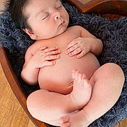 Aegon is registered to the contest to win money with this photo: newborn, baby, sleeping, infant, wooden_bowl, heart_shape, blanket, soft_texture, peaceful, cute, tiny_hands, tiny_feet, floor, indoor, portrait, skin, hair, resting, cozy, closeup
