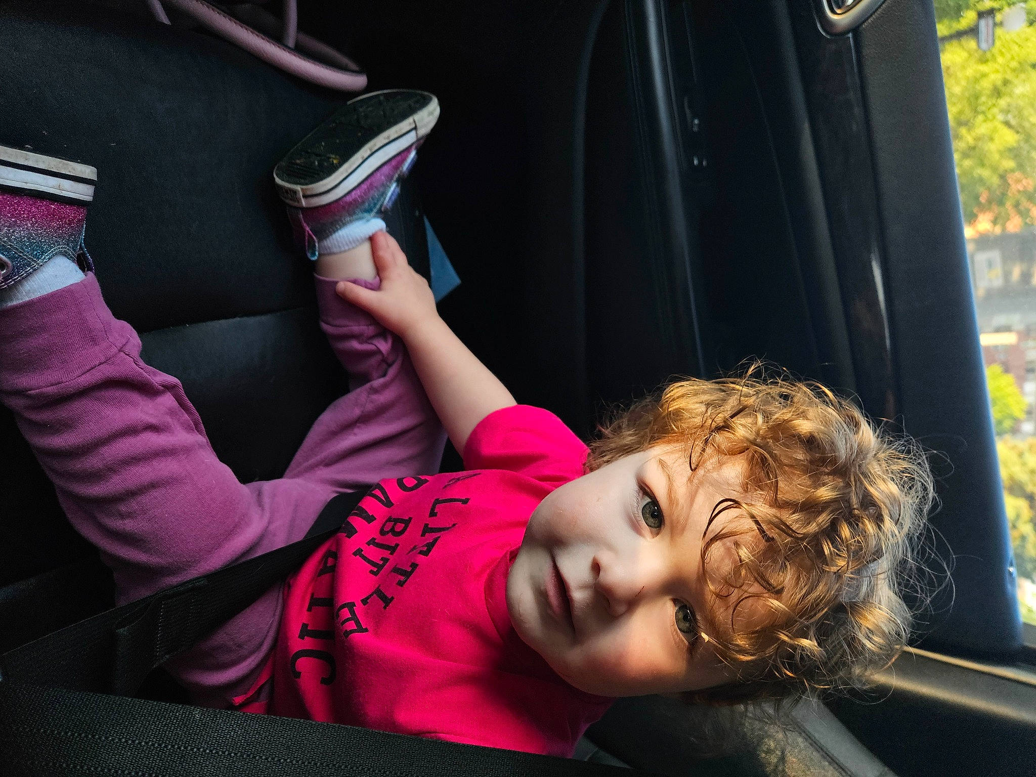 Blaine is registered to the contest to win money with this photo: audio_equipment, carmine, child, communication_device, cool, eyewear, fun, gadget, gesture, happy, human_leg, leisure, magenta, mobile_phone, nail, person, plant, sitting, toddler, tree