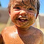 child, toddler, mud, dirty, smiling, happy, outdoor, sunlight, face, skin, hair, teeth, play, summer, nature, closeup, portrait, messy, barechested, fun