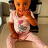 toddler, child, smiling, pink_pajamas, headwrap, kitchen_counter, cute, sitting, happy, indoor, face, person, clothing, footwear, home, portrait, baby, expression, hand, day_of_week