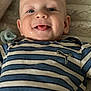 baby, child, smiling, tongue_out, striped_shirt, pacifier, blanket, closeup, happy, cute, infant, face, lying_down, blue, white, soft_texture, person, portrait, young, indoors