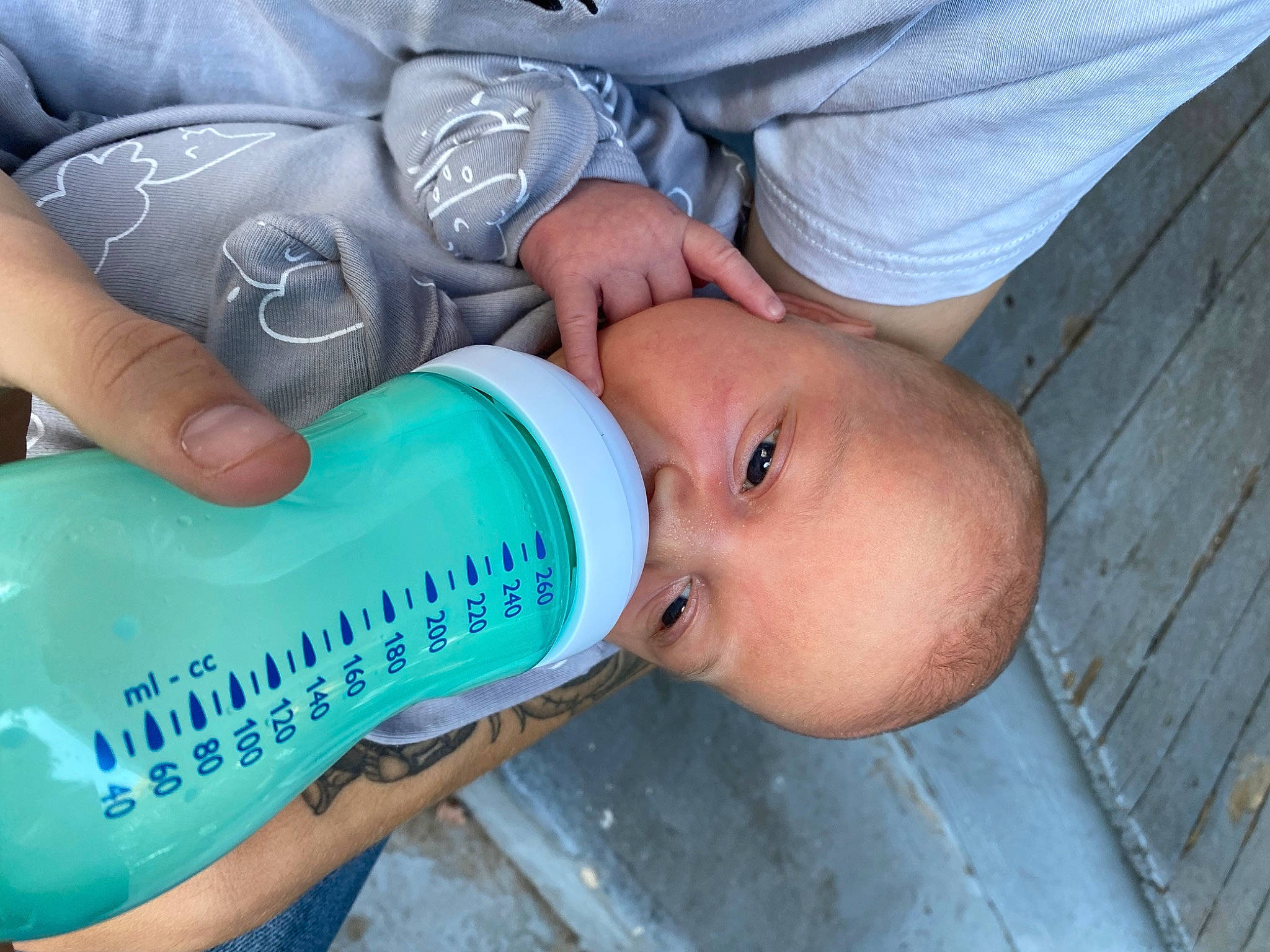 Brantley joined the competition — help win amazing prizes! baby, baby_bottle, baby_toddler_clothing, bottle, drink, drinking, drinkware, electric_blue, eyelash, finger, fluid, gesture, hand, nail, person, plastic, plastic_bottle, skin, thumb, toddler