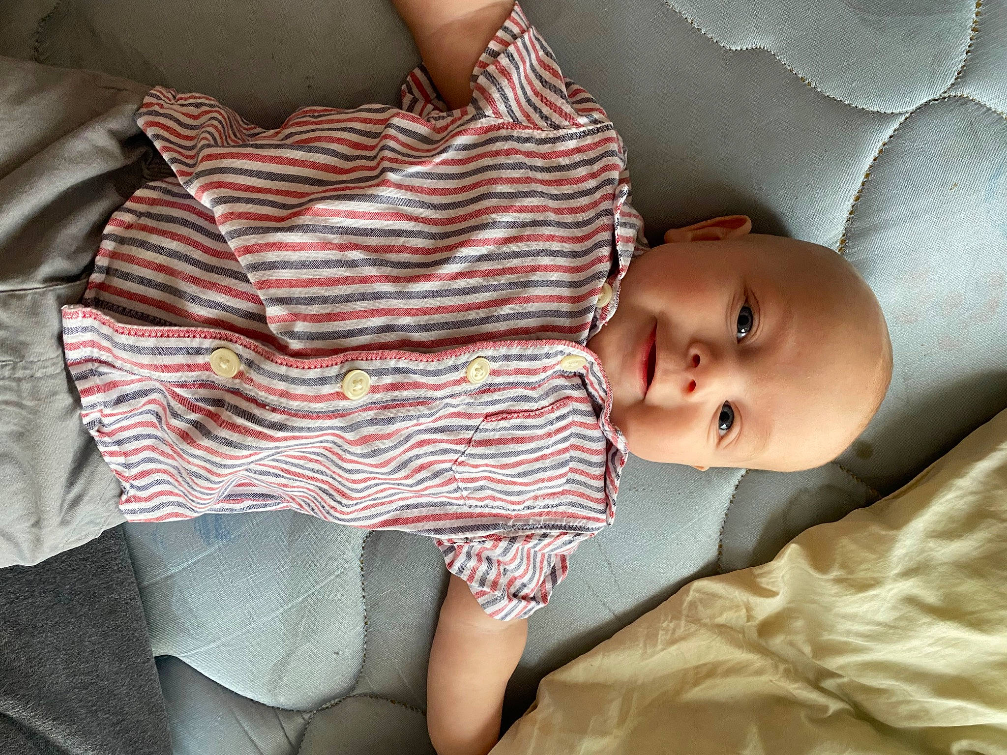 Brantley is registered to the contest to win money with this photo: baby, bedding, child, comfort, elbow, facial_expression, finger, human_leg, joint, linens, mammal, mouth, pattern, person, product, skin, sleeve, textile, thigh, toddler