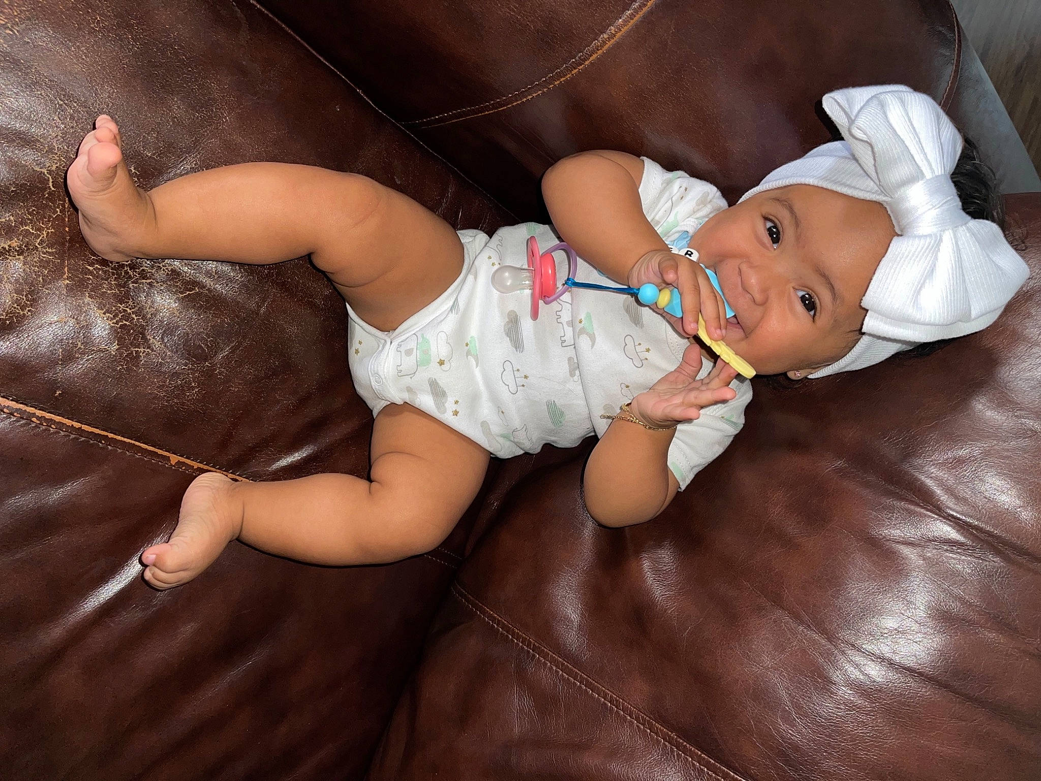 Selena Grace is registered to the contest to win money with this photo: arm, baby, baby_toddler_clothing, barefoot, child, comfort, finger, foot, fun, hat, headwear, human_body, human_leg, leg, person, sitting, skin, thigh, toddler, trunk
