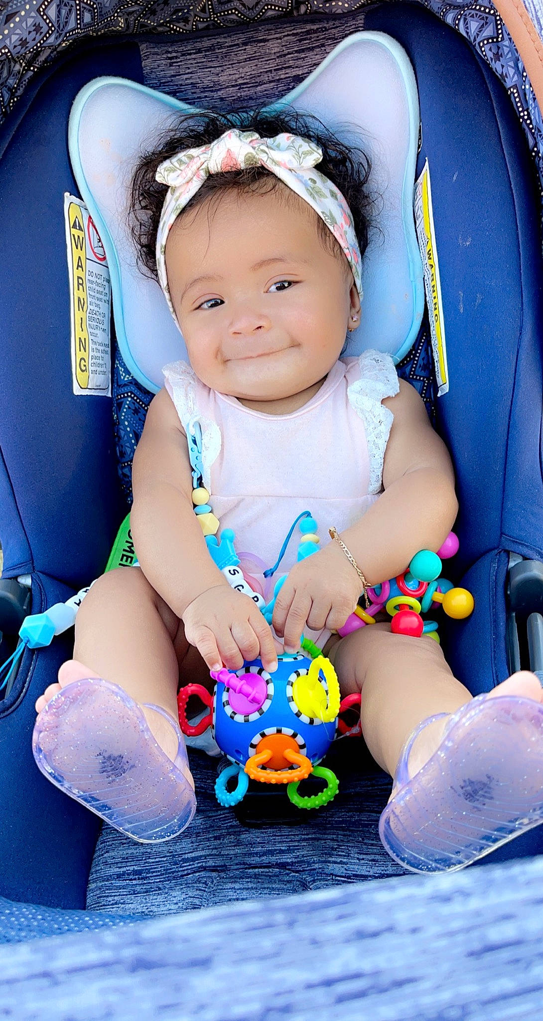 Selena Grace is registered to the contest to win money with this photo: aqua, arm, baby, baby_carriage, baby_toddler_clothing, cheek, child, comfort, facial_expression, finger, hand, happy, head, joy, person, pink, product, purple, skin, smile