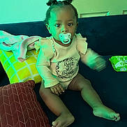 Armani joined the competition — help win amazing prizes! toddler, child, pacifier, couch, pillow, baby, indoor, sitting, clothing, door, hair, face, foot, hand, room, furniture, young_child, expressionless, light, home