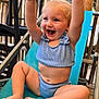 toddler, child, smiling, happy, blonde_hair, blue_eyes, sitting, raising_hands, lounge_chair, outdoor, wooden_railings, casual_clothing, two_piece_outfit, cute, playful, barefoot, daylight, portrait, baby, joyful