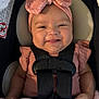 baby, infant, smile, headband, pink, blanket, car_seat, child, happy, cute, face, clothing, ribbons, seatbelt, portrait, indoors, person, baby_girl, adorable, infant_girl