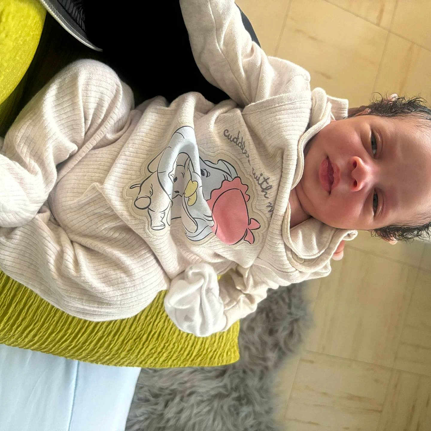 Lyam participe au concours pour gagner de l'argent avec cette photo : animal_print, baby, blanket, child, clothing, cream, curly_hair, cushion, expression, face, floor, home_interior, indoor, infant, lying_down, person, portrait, ribbed, soft_texture, yellow