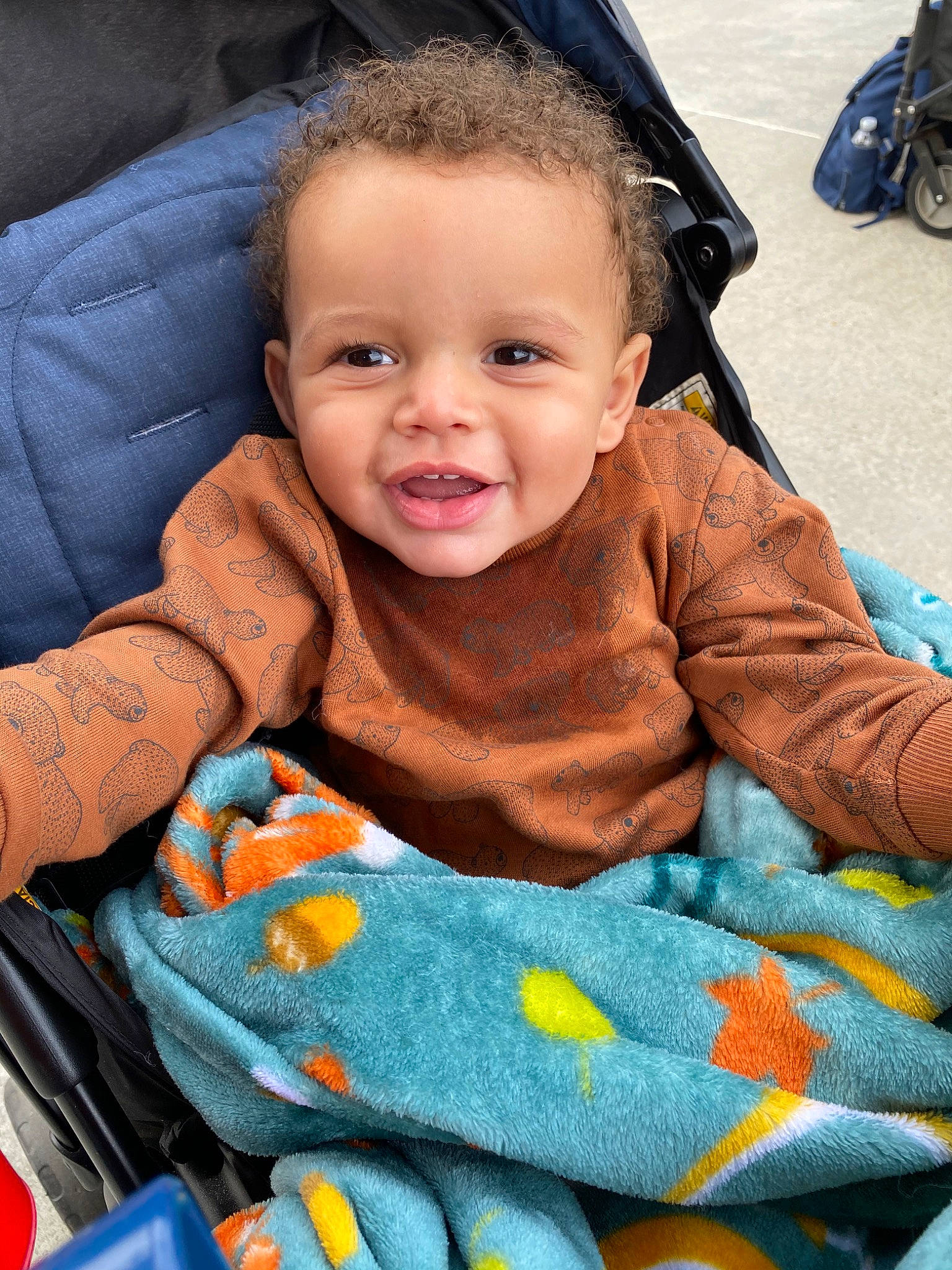 Samari is registered to the contest to win money with this photo: baby, baby_carriage, baby_products, baby_safety, baby_toddler_clothing, cheek, child, comfort, lap, motorcycle, nose, orange, person, product, sitting, synthetic_rubber, toddler