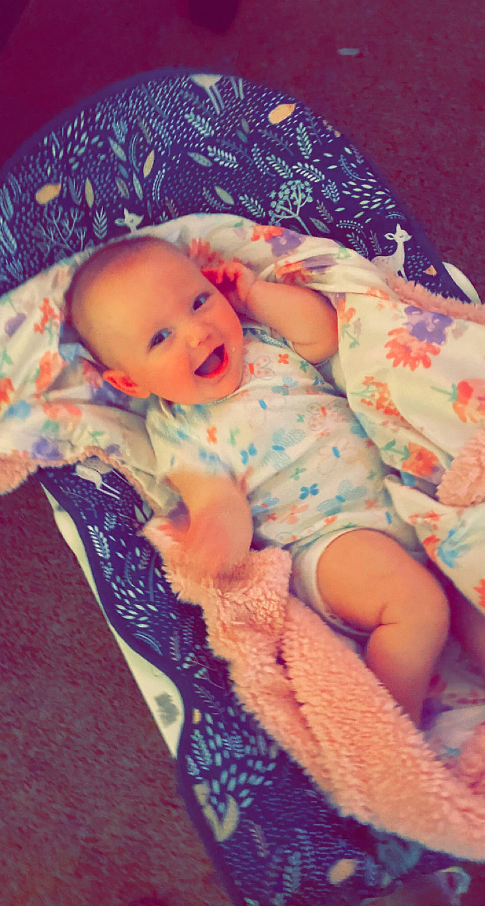 Isla is registered to the contest to win money with this photo: arm, baby, baby_toddler_clothing, cheek, comfort, eye, hand, human_body, iris, leg, lip, mouth, muscle, nose, orange, person, pink, purple, skin, smile