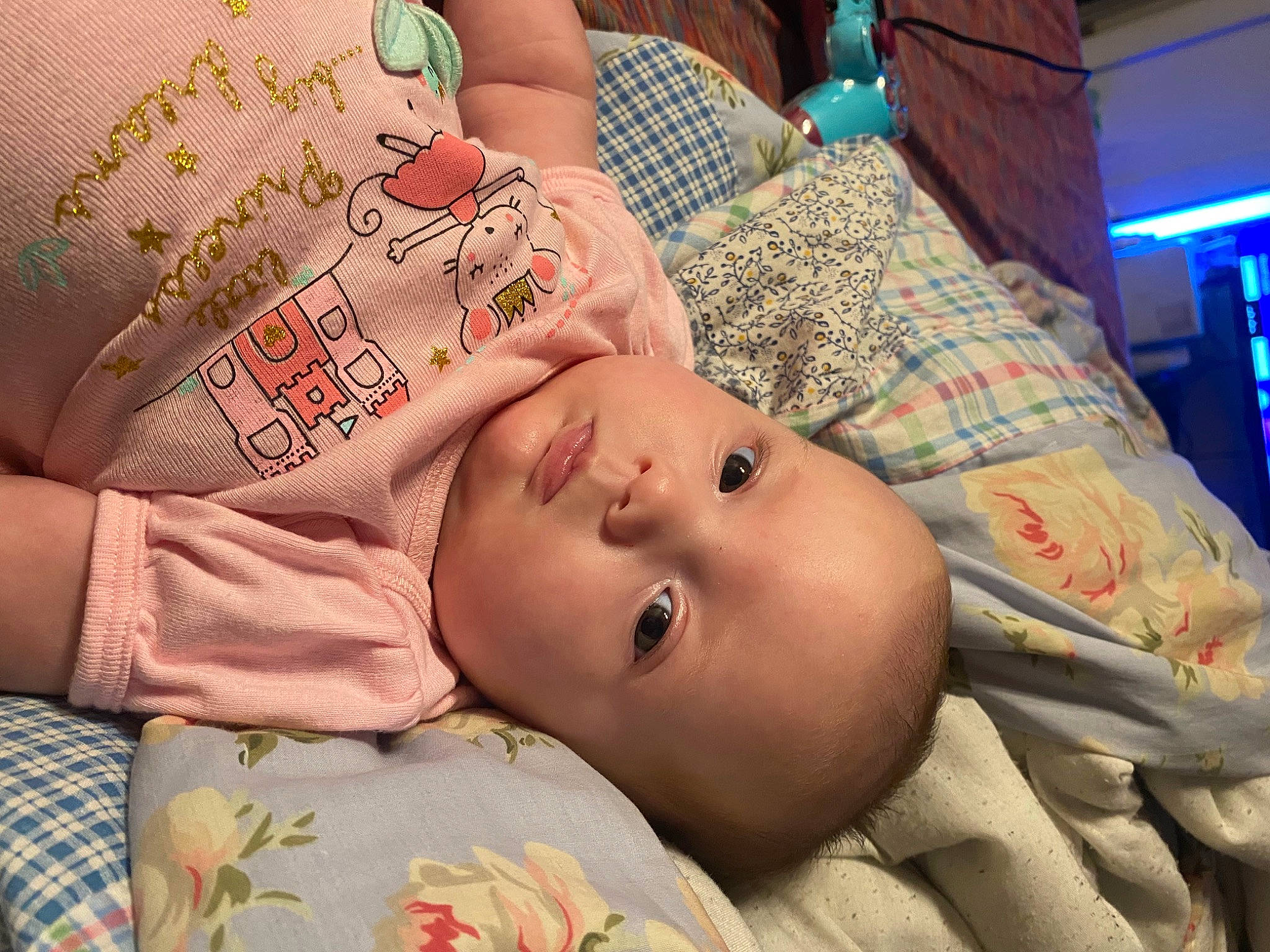 Isla is registered to the contest to win money with this photo: baby, baby_products, baby_toddler_clothing, bedding, bedtime, cheek, child, comfort, eyebrow, eyelash, finger, hand, linens, mouth, nose, pattern, person, skin, sleeve, textile