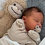 baby, newborn, sleeping, pacifier, plush_toy, stuffed_animal, monkey, blanket, soft_toy, infant, cozy, cute, child, bed, sleep, clothing, fabric, rest, comfort, portrait