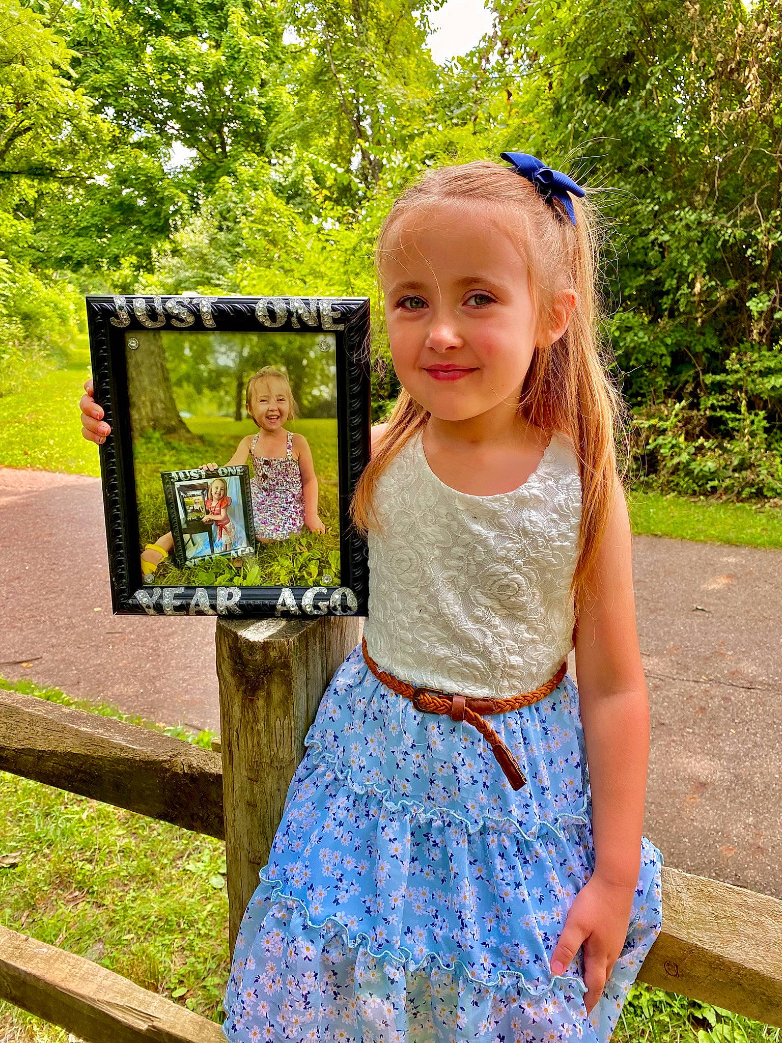 Emelia is registered to the contest to win money with this photo: baby_toddler_clothing, clothing, day_dress, face, facial_expression, fun, grass, green, happy, joy, people, people_in_nature, person, pink, plant, smile, standing, summer, sunglasses, toddler