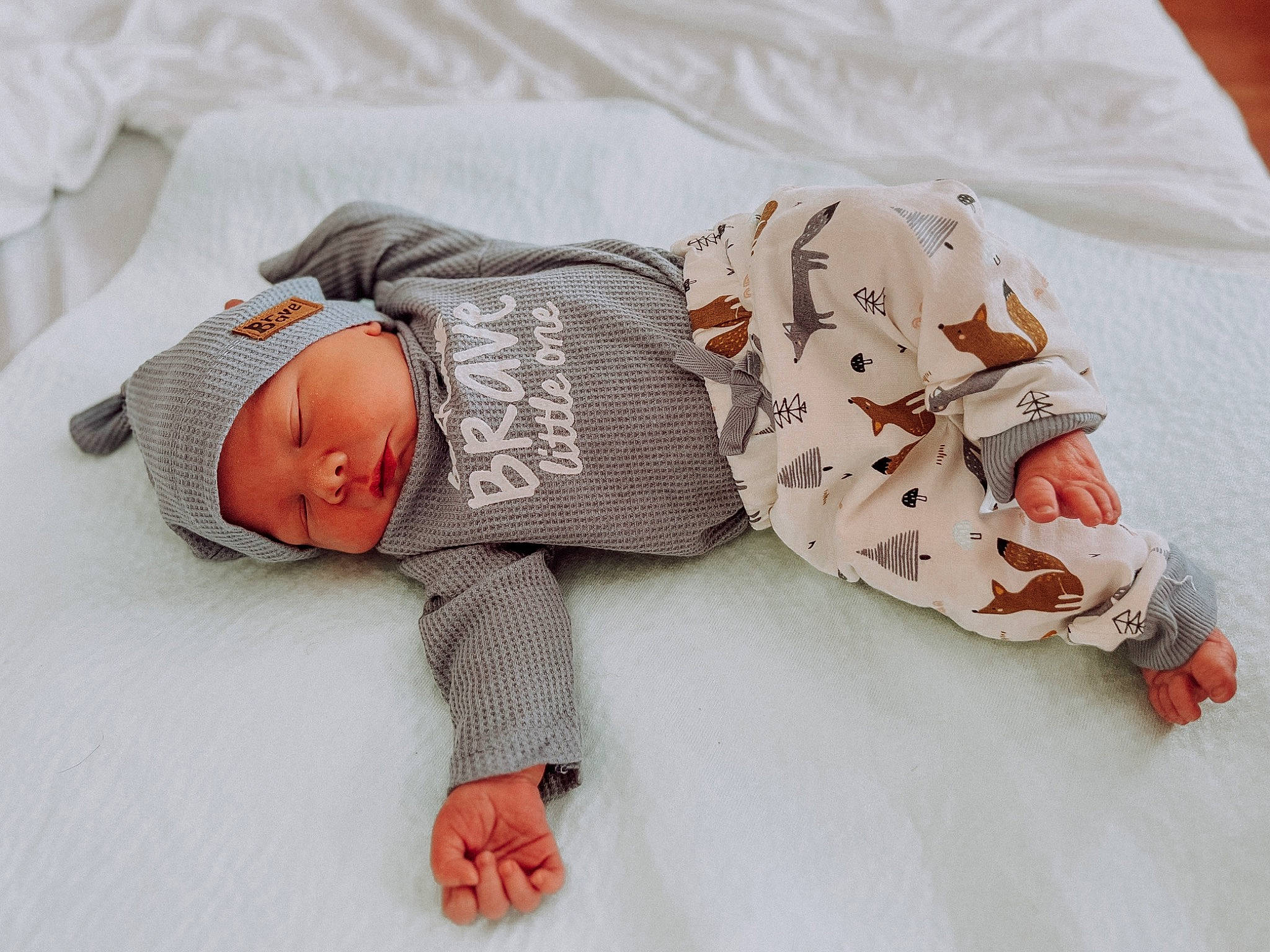 Bennett is registered to the contest to win money with this photo: arm, baby, baby_products, baby_sleeping, baby_toddler_clothing, bedding, bedtime, child, comfort, hand, hat, headgear, headwear, human_body, linens, mammal, pattern, person, skin, sleeve