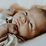 Rafaël a rejoint le concours — aidez-le/la à gagner de superbes lots ! baby, child, close_up, clothing, cute, expression, face, hand, indoors, infant, lying_down, newborn, peaceful, portrait, resting, skin, sleepy, soft_light, tiny, young