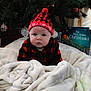Everett is registered to the contest to win money with this photo: baby, christmas_tree, blanket, holiday, festive, hat, red_and_black, plaid, indoors, child, decorations, ornaments, book, cozy, winter, cute, portrait, holiday_season, smiling, warm