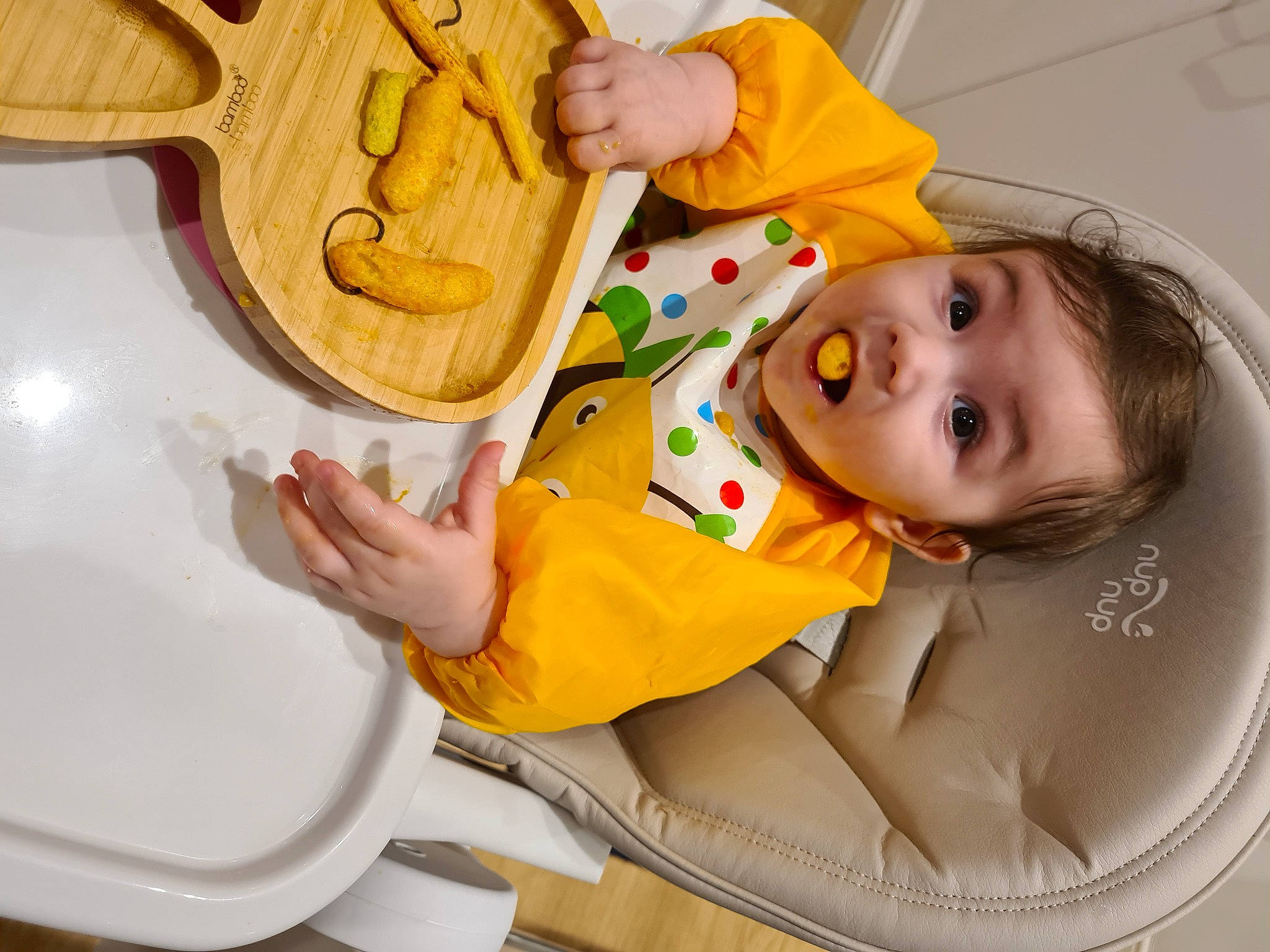Elisa is registered to the contest to win money with this photo: baby, baby_products, baby_toddler_clothing, child, cooking, hand, kitchen_utensil, person, surprise, toddler, yellow