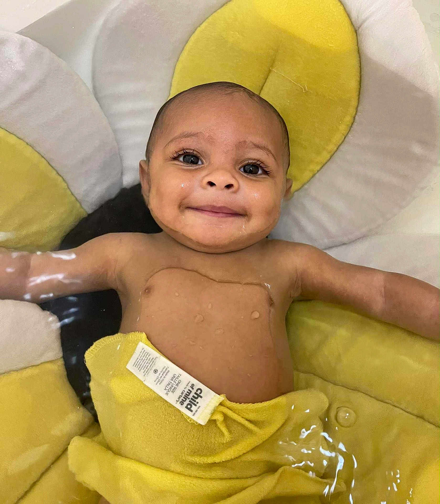 Josiah joined the competition — help win amazing prizes! baby, child, smile, water, tub, yellow, white, padded, floating, happy, infant, skin, face, eyes, arms, cute, childcare, bath, towel, relaxation