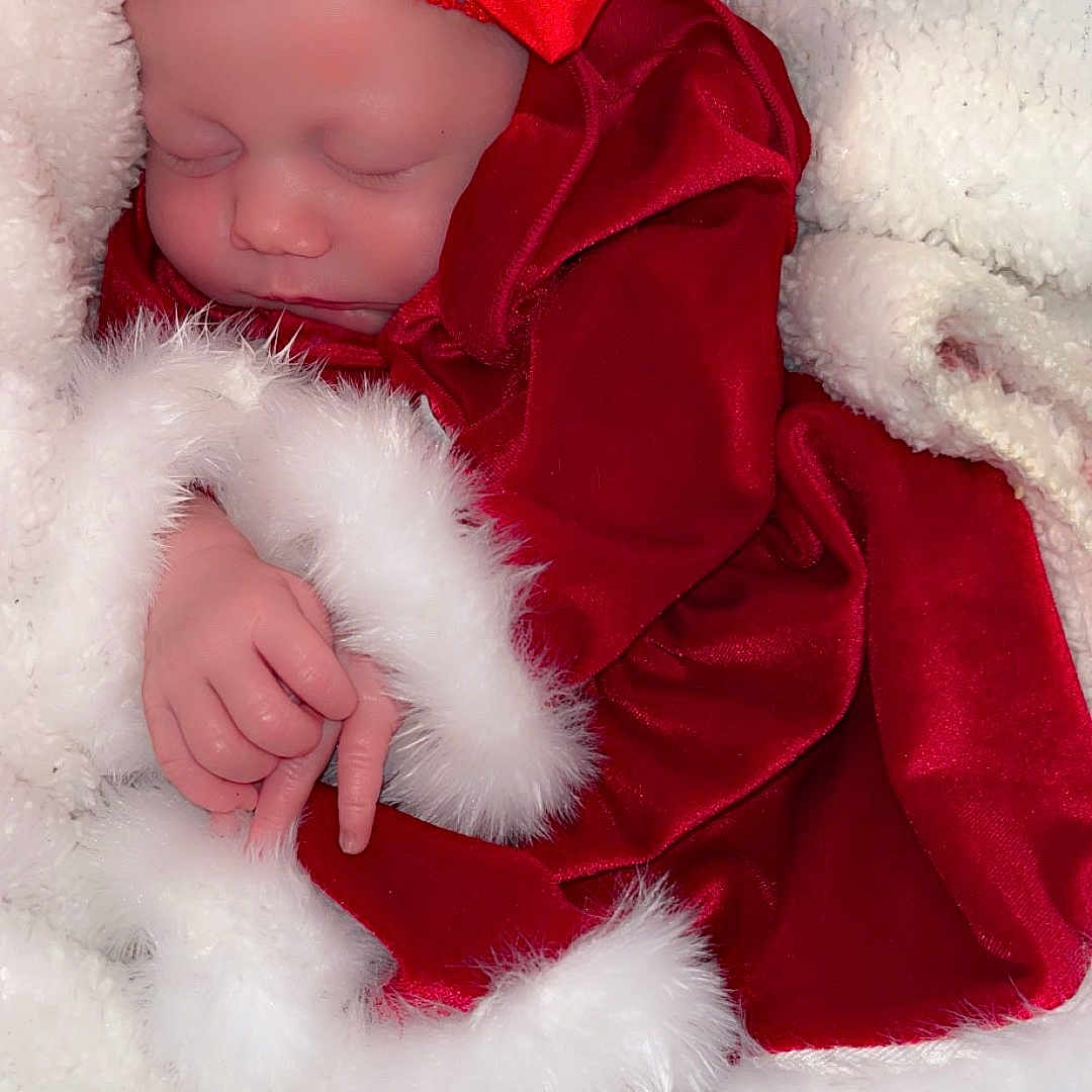 Lyra is registered to the contest to win money with this photo: baby, blanket, bodypart, bonnet, clothing, costume, dress, face, finger, hand, hat, head, hood, newborn, person, photography, portrait, sleeping, toy, velvet