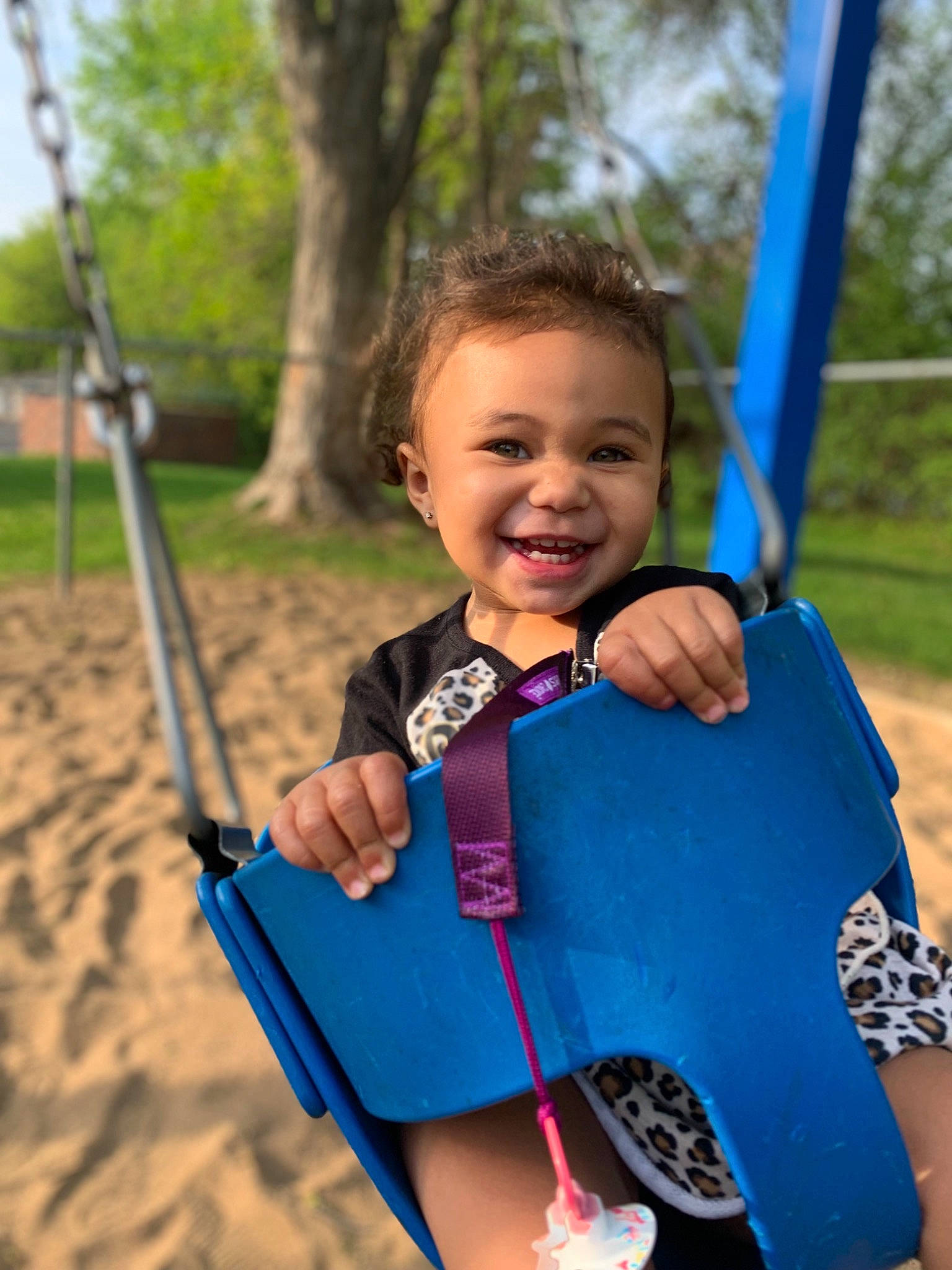 Macy is registered to the contest to win money with this photo: child, city, electric_blue, eye, face, fun, grass, hair, happy, joy, leisure, outdoor_play_equipment, person, plant, playground, recreation, skin, smile, summer, swing