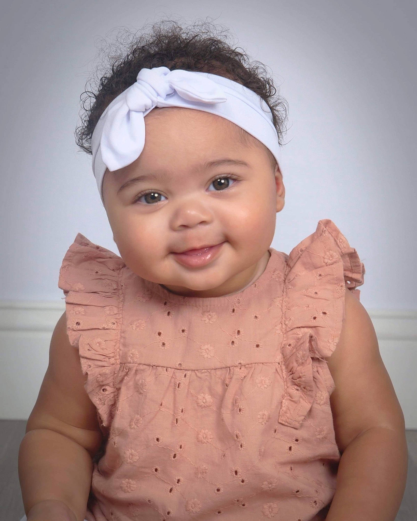 Aura is registered to the contest to win money with this photo: baby, baby_toddler_clothing, cap, cheek, chin, face, flash_photography, gesture, happy, headwear, iris, joy, lip, mouth, neck, nose, outerwear, person, skin, sleeve