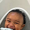 Messiah is registered to the contest to win money with this photo: baby, child, smiling, happy, bath, towel, wet_hair, curly_hair, infant, cute, face, skin, hand, sitting, plastic, seat, portrait, closeup, water, playful