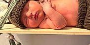 Jaxon joined the competition — help win amazing prizes! newborn, baby, sleeping, hat, knitted, wooden_swing, macrame, tassels, beads, cute, peaceful, infant, hand, skin, cuddle, rest, indoors, decor, soft, cozy