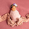 newborn, baby, sleeping, pink, blanket, headband, flower, portrait, wrapped, bow, soft_texture, peaceful, infant, cute, cozy, closeup, child, studio, resting, adorable
