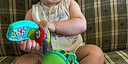 Maverick joined the competition — help win amazing prizes! baby, child, toy, couch, plaid, smile, happy, sitting, indoor, person, infant, clothing, foot, hand, face, play, colorful, cute, expression, furniture