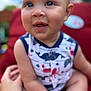 Maverick joined the competition — help win amazing prizes! baby, child, smiling, face, arm, hand, clothing, onesie, outdoor, red_cushion, seat, person, happy, cute, infant, skin, expression, portrait, summer, sunlight