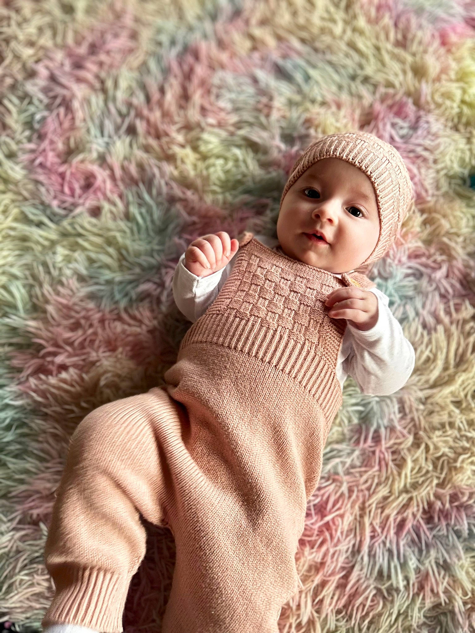 Ariel is registered to the contest to win money with this photo: baby, baby_toddler_clothing, cheek, child, face, grass, grass_family, happy, head, headwear, leaf, outerwear, pattern, people_in_nature, person, plant, sitting, skin, sleeve, toddler