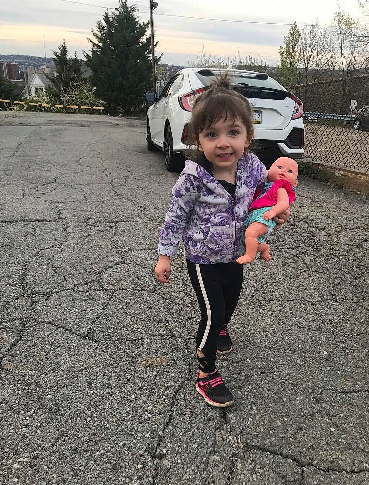 Maeby is registered to the contest to win money with this photo: asphalt, car, child, joy, mountain, person, pink, plant, play, recreation, shoe, toddler, tree, vacation, vehicle, winter