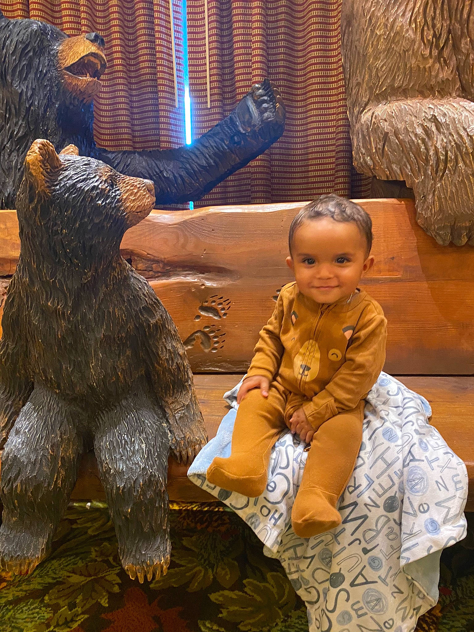 Benjamin is registered to the contest to win money with this photo: art, bear, brown_bear, child, event, flooring, fun, fur, grizzly_bear, happy, human, human_body, joy, lawn_ornament, leisure, person, smile, snapshot, temple, toddler