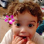 Honesty joined the competition — help win amazing prizes! toddler, child, curly_hair, face, hands, flower_filter, indoors, carpet, couch, playful, expression, person, cute, baby, smiling, eyes, fingers, casual, home, young_child