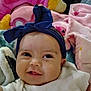 baby, headband, smile, infant, blanket, soft_toys, pink, blue, white_clothing, face, cheeks, eyes, portrait, cute, indoors, child, happy, closeup, cozy, baby_bow