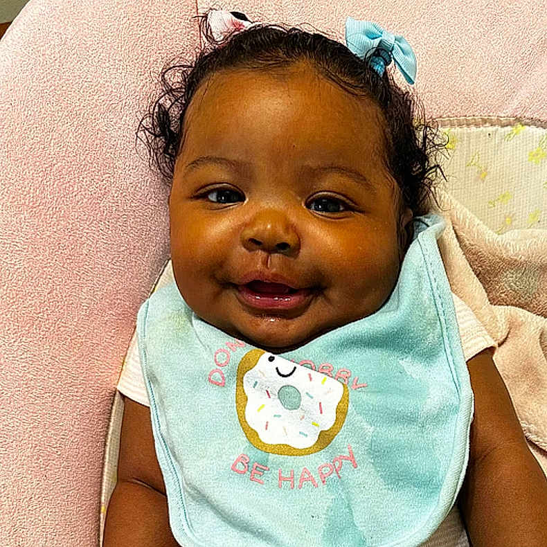 Janiya joined the competition — help win amazing prizes! baby, babylaughing, bib, bodypart, face, happy, head, person, shoulder, smile