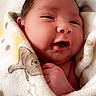 newborn, baby, infant, child, portrait, face, smiling, eyes, mouth, hair, blanket, swaddled, cozy, indoors, bed, lying_down, close_up, photography, adorable, safe