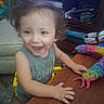 Ezra joined the competition — help win amazing prizes! toddler, child, smiling, happy, portrait, indoor, table, wooden_table, toy, colorful_toy, rainbow, stuffed_toy, shelves, books, furniture, home, seated, brown_hair, green_shirt, playtime