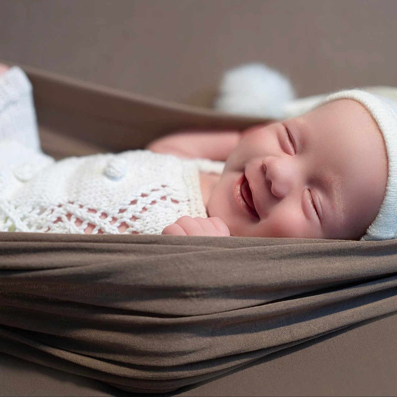Evie is registered to the contest to win money with this photo: baby, baby_clothing, child, cozy, cute, fabric, hammock, happy, indoors, infant, knit_hat, knit_outfit, newborn, peaceful, portrait, resting, sleeping, smiling, soft_texture, wrapped