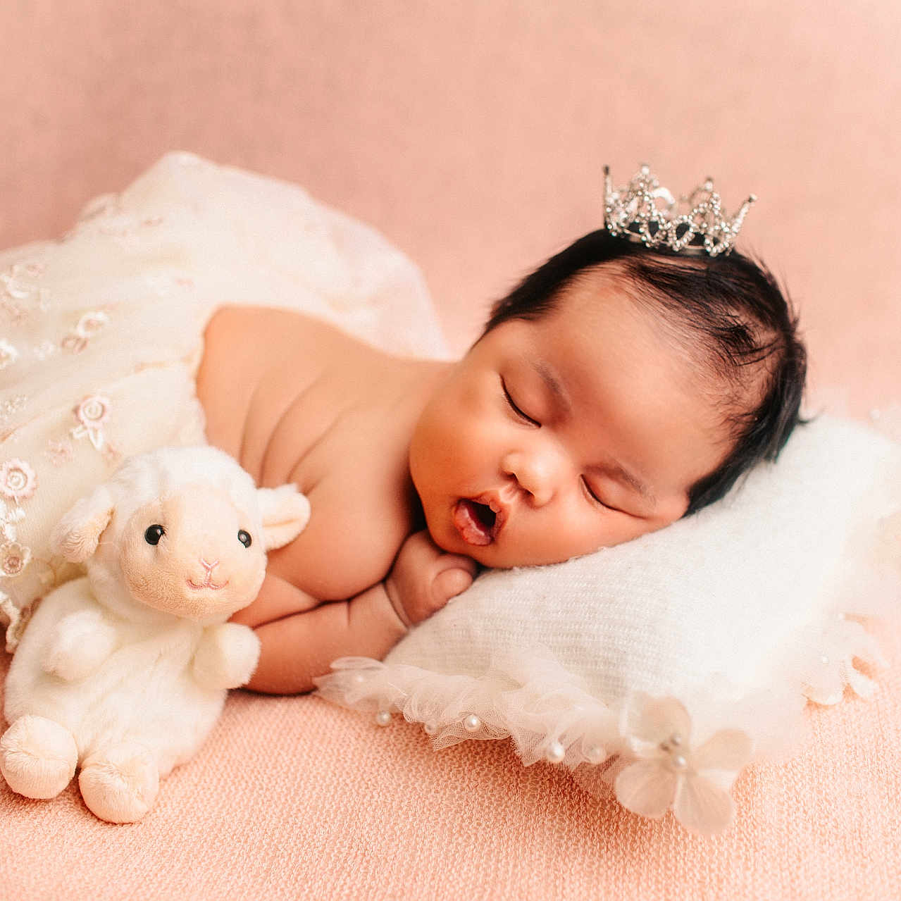 Harret Eloise joined the competition — help win amazing prizes! baby, sleeping, crown, plush_toy, lamb, pillow, lace_skirt, soft_texture, peach_background, infant, cute, resting, adorable, child, portrait, peaceful, newborn, soft_lighting, cozy, indoor